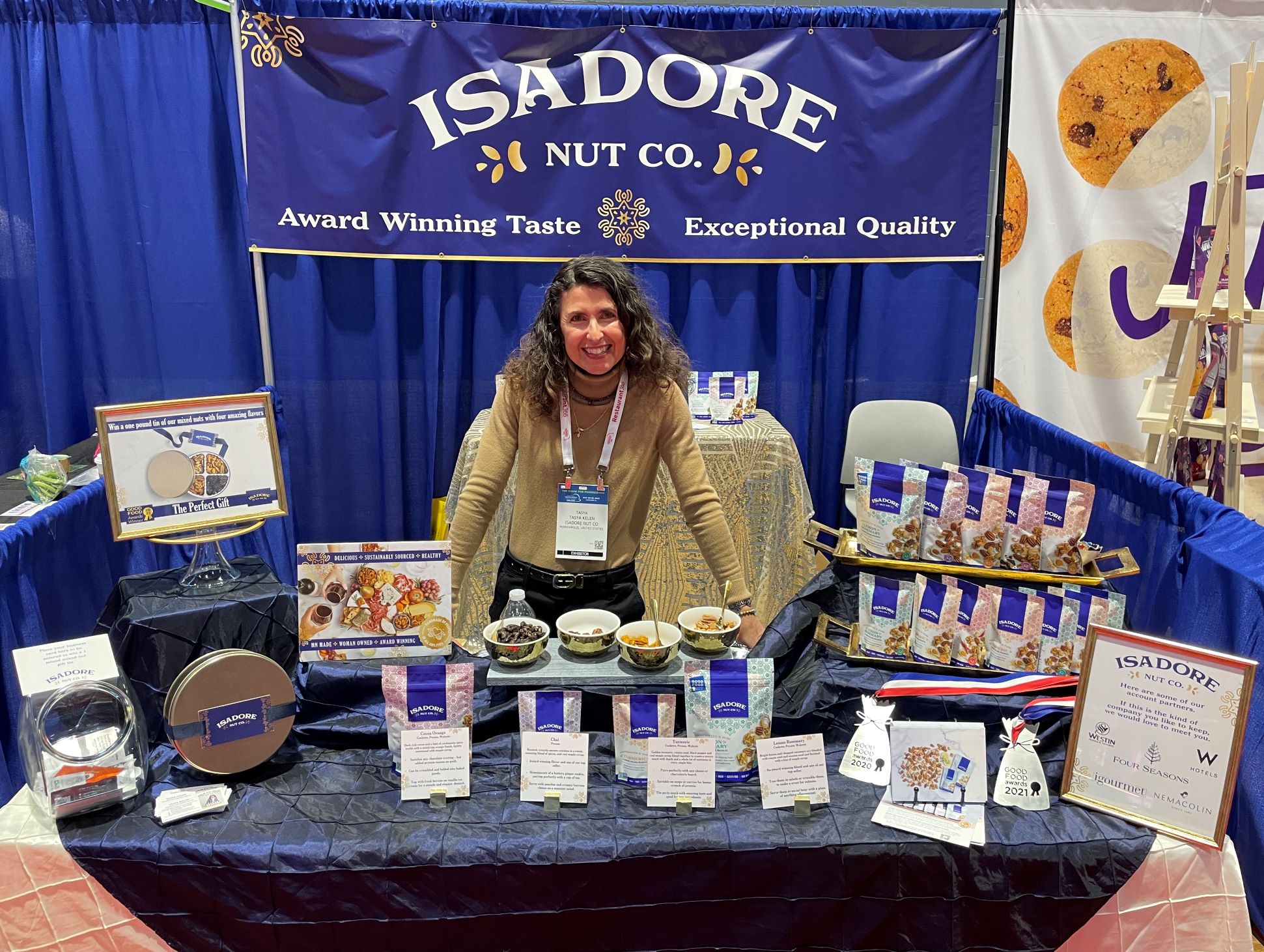 woman standing behind her trade show display selling nuts