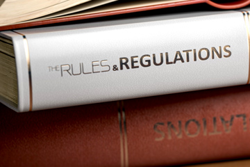 Stack of books regarding rules and regulations.