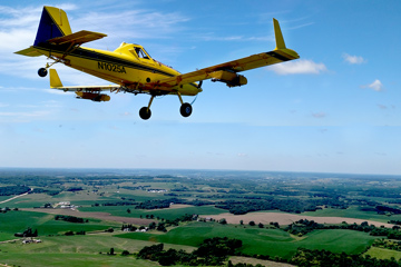 yellow plane flying 